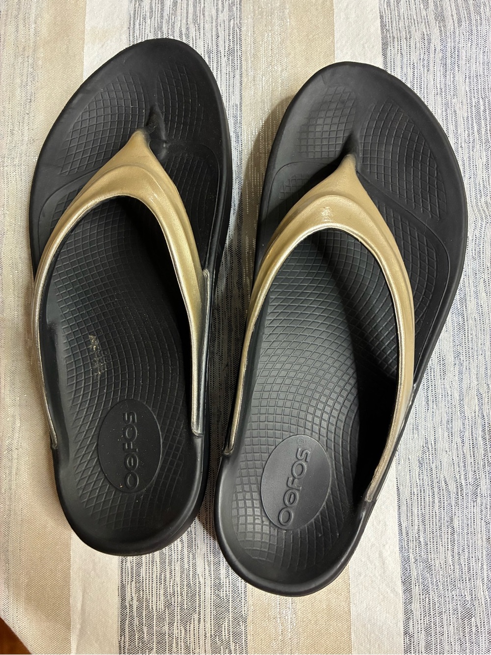 OOFOS Black Flip Flops with Gold Straps size 9